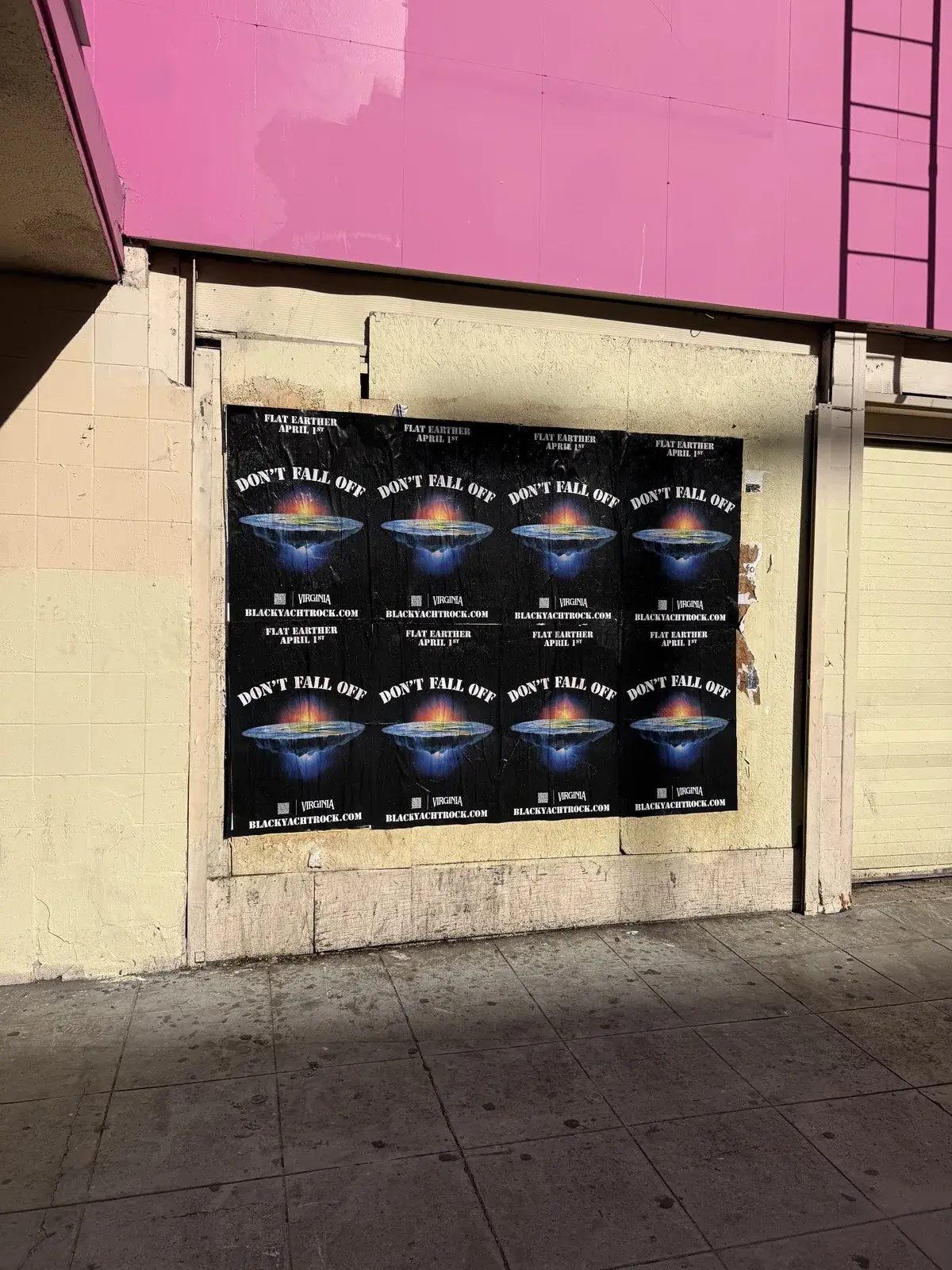 Don't Fall Off wheat paste posters on urban wall with pink accent guerrilla marketing